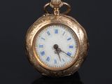 an antique gold pocket watch with roman numerals and roman numerals on the face