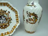 two vases and a plate with a picture of a dragon on them