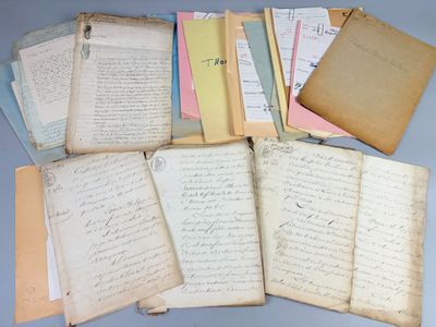 an assortment of old letters and papers on a table