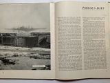 an open book with a picture of a train in the background