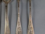 five spoons and a fork on a table