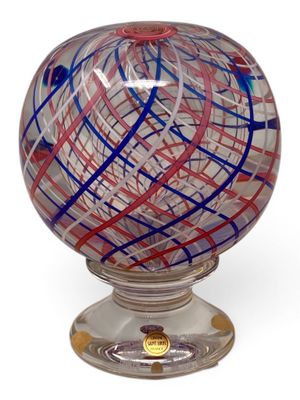 a glass ball with a red and blue design on it