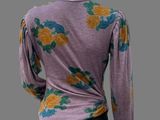an image of a mannequin wearing a purple top with yellow and blue flowers