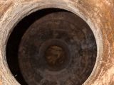 a close up view of a rusted vase with a hole in the middle