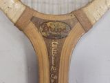 a close up of a tennis racket with a sign on it