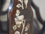 a close up of a wooden table with flowers on it
