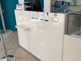 an image of a pharmacy office with a counter and stools