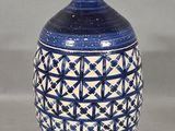 a blue and white vase sitting on a table