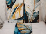 two paintings on a bed with white sheets and a white sheet