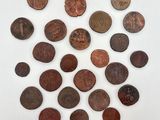 a pile of old coins sitting on top of a white surface