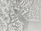 a close up of a glass vase with a deer on it