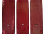three red skateboards sitting side by side on a white surface