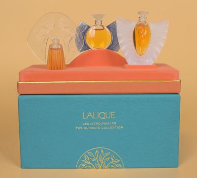 an image of a box with a perfume bottle and a perfume brush