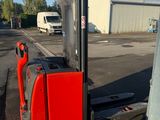 a red forklift with a blue box on the back