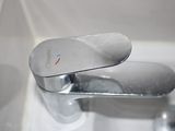 a close up of a chrome faucet in a bathroom