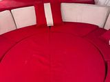 a red couch in the center of a white boat