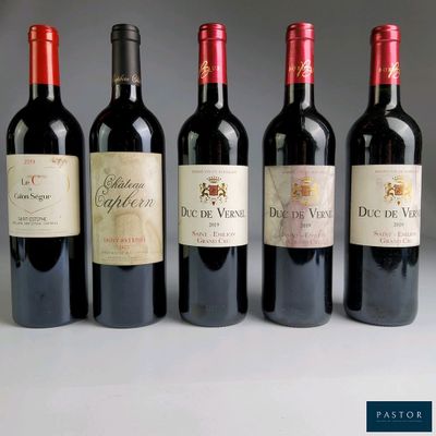 six bottles of wine are lined up in a row on a table