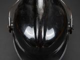 black helmet on a black surface with a black background