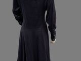 the back view of a mannequin wearing a black dress