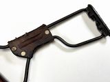 a wooden handle with a black handle on a white surface