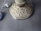 a silver lamp that has a cord attached to it