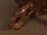 a wooden table with a carved animal on it