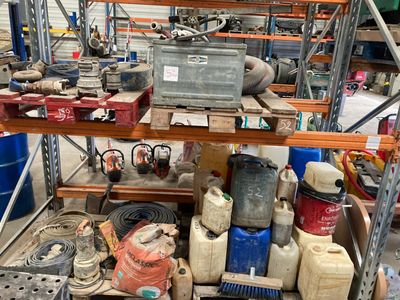 a lot of assorted items on a shelf in a warehouse