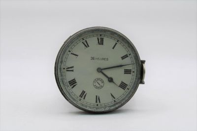 a small clock with roman numerals on the face