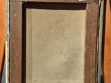 an old wooden easel with a painting on top of it