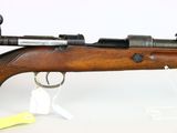 an old rifle with a wooden barrel on a white background