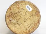 a brown vase with writing on it sitting on a white surface