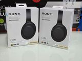 two sony wireless headphones are sitting on a table in a store