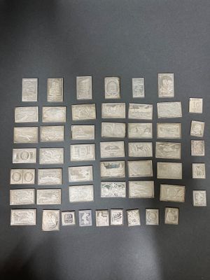 a lot of stamps on a table with a black background
