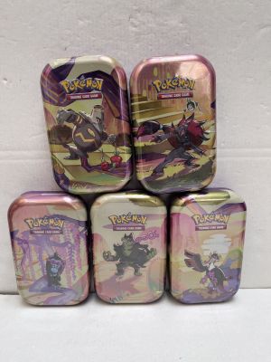 four tins of pokemon tins are stacked on top of each other