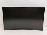 a large black television sitting on top of a white table