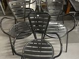 plusieurs chaises et une table dans une pièce où se trouve un ordinateur portable posé sur la table