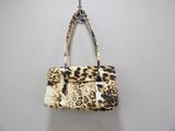 beige and black leopard print purse hanging on a wall