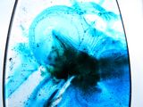 a close up of a blue and black glass object