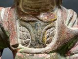 a statue of a person holding a bowl of food