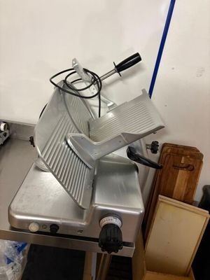 an image of a commercial meat slicer in a kitchen