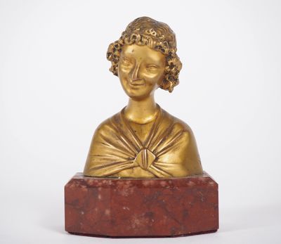 a gold statue of a woman on a red marble base