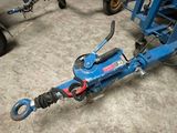 a blue tow truck that is parked in a garage