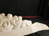 a white sculpture of a group of people on a boat