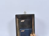 a small wooden box with a clock inside of it