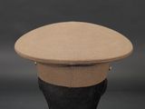 beige wool cap on a mannequin head on a black background