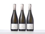 three bottles of wine sitting on top of a table next to each other
