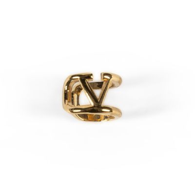 a gold ring with the letter v on it