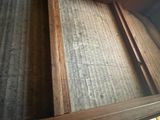 a window that has a wooden frame on it