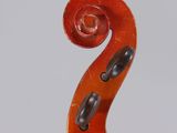 a close up of a violin with a red bow on a white background