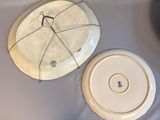 a white plate with a hole in it and a white plate with a hole in it